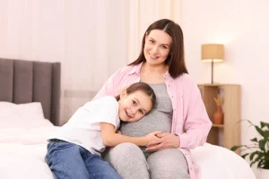 Happy surrogate with her own child representing the process of choosing the right surrogacy agency